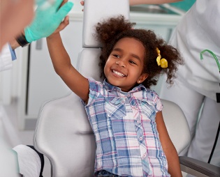 Little girl giving dentist high five