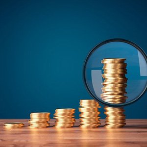 Stacks of coins examined with magnifying glass