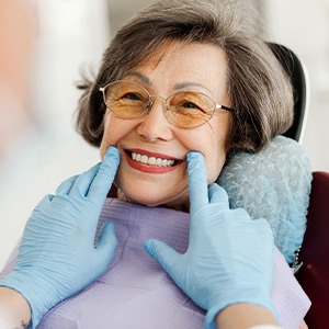 Dentist looking at patient's smile in treatment chair