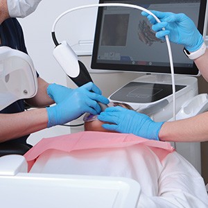 Dentist in Haverhill using a digital impression scanner on a patient