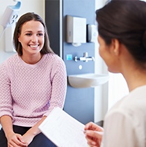 Woman in dental chair smiling