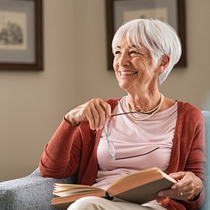 Senior woman reading a book and smiling