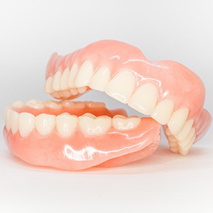 Close-up of two full dentures on white background