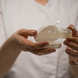 Person holding a mouthguard