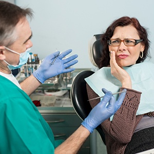 Woman in pain visiting an emergency dentist