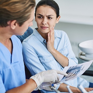 Dentist showing emergency dentistry patient an X-ray