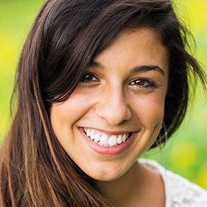 Woman with gorgeous smile after gum disease therapy