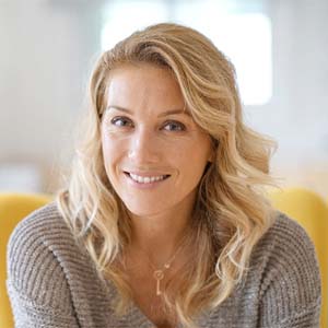 Woman smiling after dental implant treatment