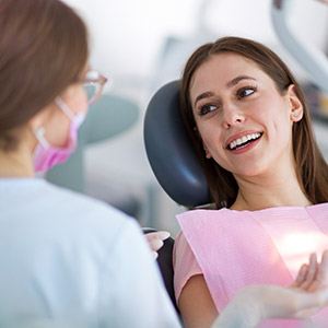 Woman smiling during dental checkup and teeth cleaning