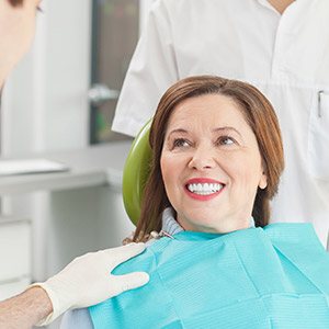 Senior woman smiling during gum disease therapy