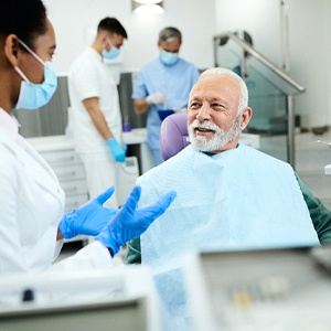 Dental patient learning about the cost of root canal therapy