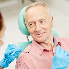 Older man in dental chair for cosmetic dentistry