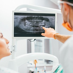 Dentist and patient looking at dental x-rays