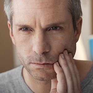 Man with toothache before tooth extraction