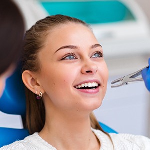 Woman smiling during tooth extraction