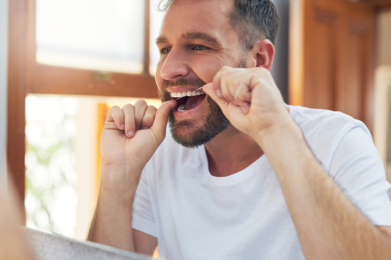 Patient scratching their teeth trying to protect dental health